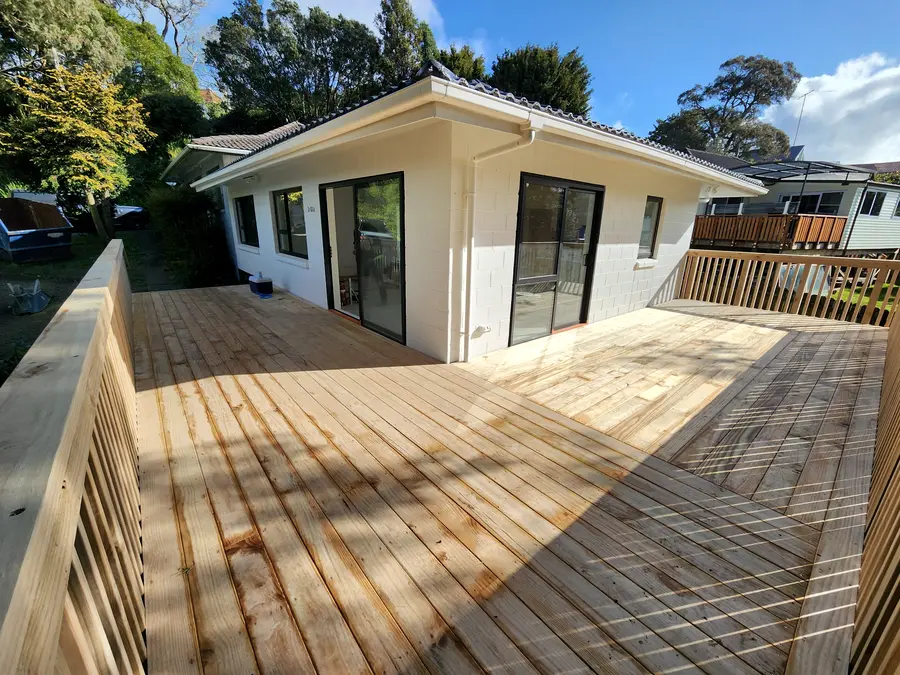 After: a new pale timber deck and freshly painted unit